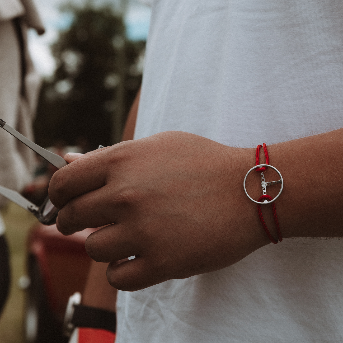 Man is wearing the Silver Classic Steering Wheel.